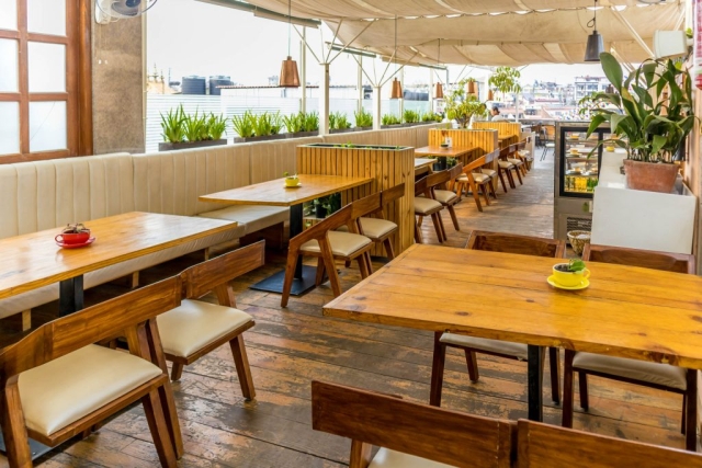 Rooftop seating area with a menu offering a variety of dining options and scenic views.