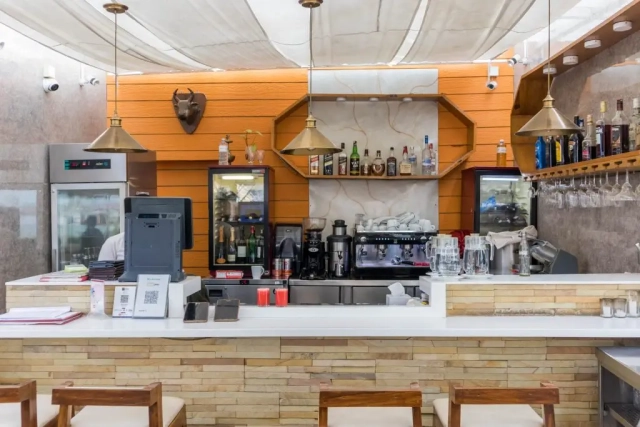 Counter at the rooftop restaurant, featuring a selection of drinks and dishes with a view