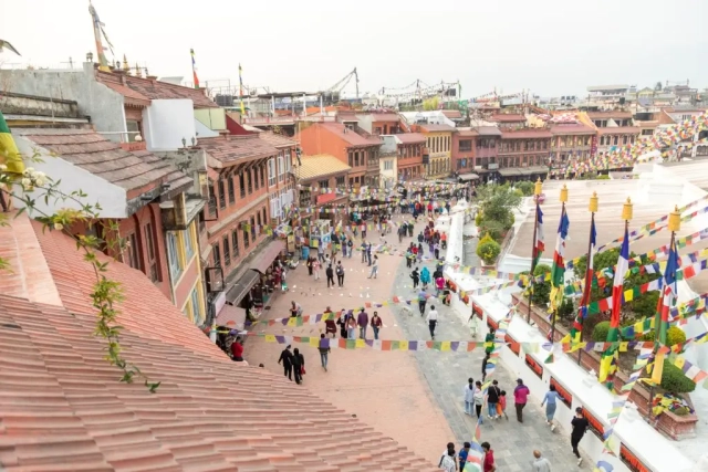 View from the balcony of Hotel Padma's Stupa View Suite, showing people walking around the Stupa.
